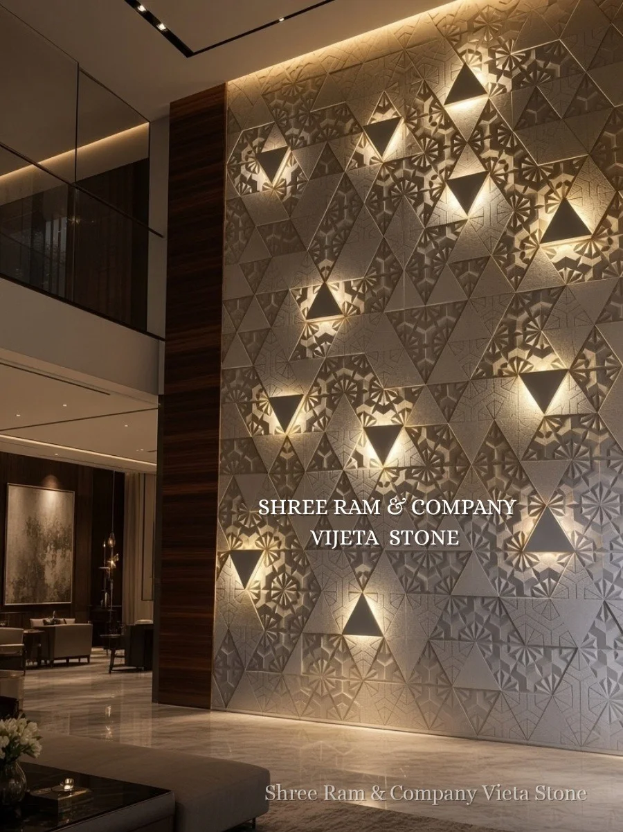 3D geometric faceted triangular sandstone cladding with illuminated niches and floral relief carvings in modern double-height atrium - Shree Ram and Company Vijeta Stone