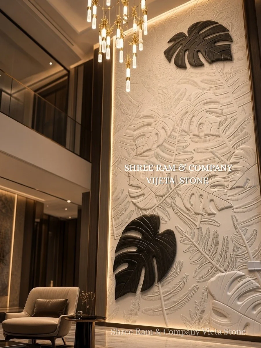 Grand botanical monstera and tropical foliage bas-relief carved stone mural with contrasting charcoal leaf accents in double-height villa hall - Shree Ram and Company Vijeta Stone